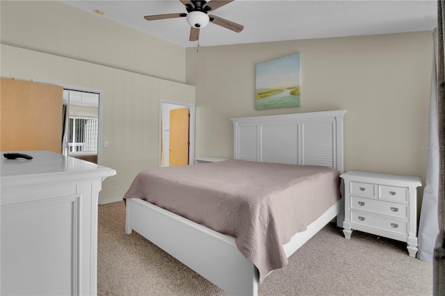 bedroom featuring light carpet, a ceiling fan, and vaulted ceiling