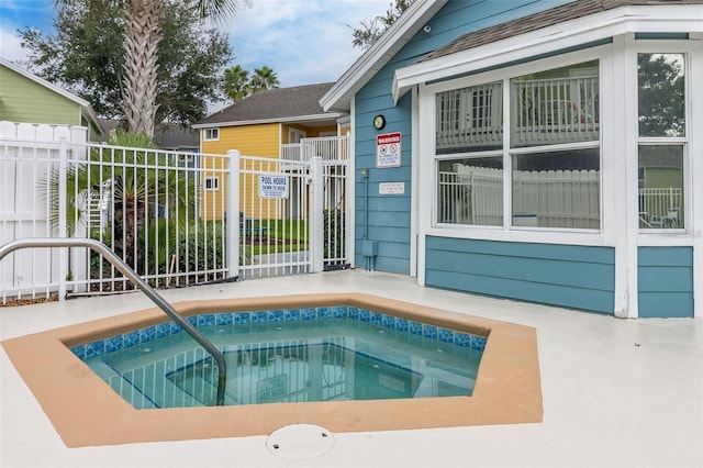 view of pool featuring fence and a community hot tub