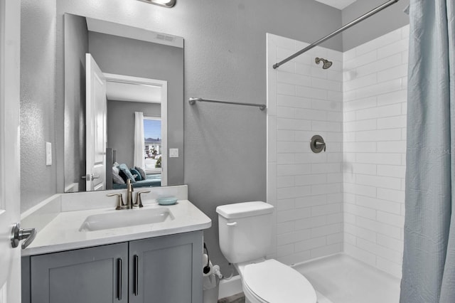 bathroom with vanity, toilet, and curtained shower