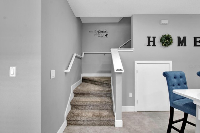 staircase featuring tile patterned flooring