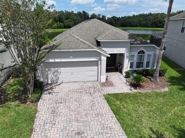 ranch-style house with decorative driveway, a garage, roof with shingles, and stucco siding