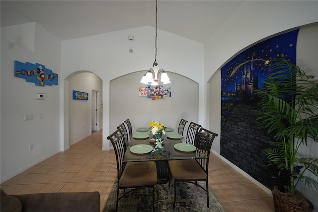 tiled dining room with an inviting chandelier and high vaulted ceiling