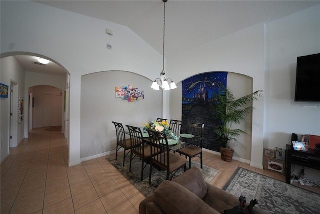 dining area featuring high vaulted ceiling, light tile patterned floors, and a notable chandelier