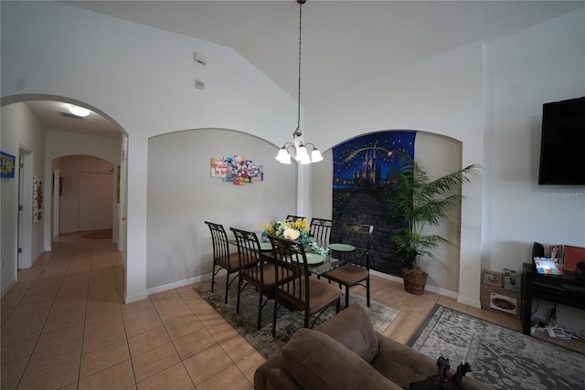 tiled dining room with baseboards, arched walkways, a notable chandelier, and high vaulted ceiling