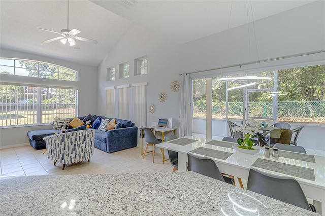 interior space featuring high vaulted ceiling, ceiling fan, and light tile patterned floors