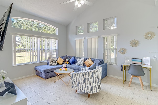 tiled living room with a wealth of natural light, ceiling fan, and high vaulted ceiling