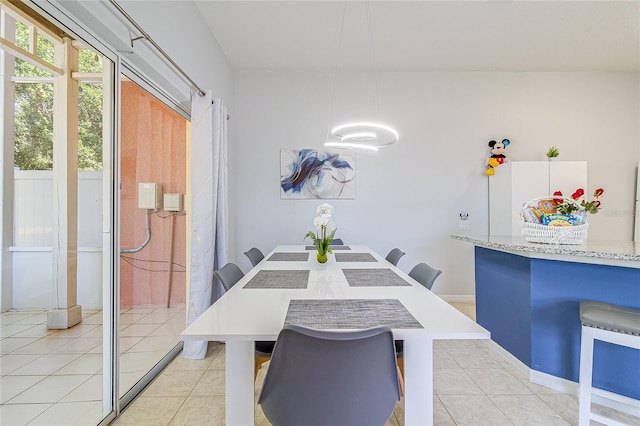 dining area featuring light tile patterned flooring