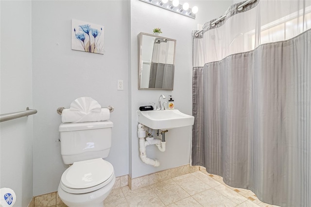 bathroom with tile patterned flooring and toilet