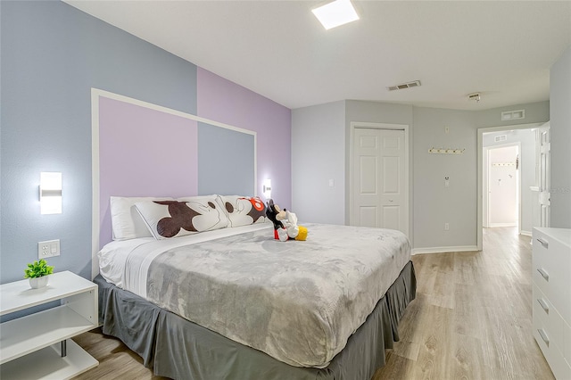 bedroom featuring a closet and light hardwood / wood-style floors