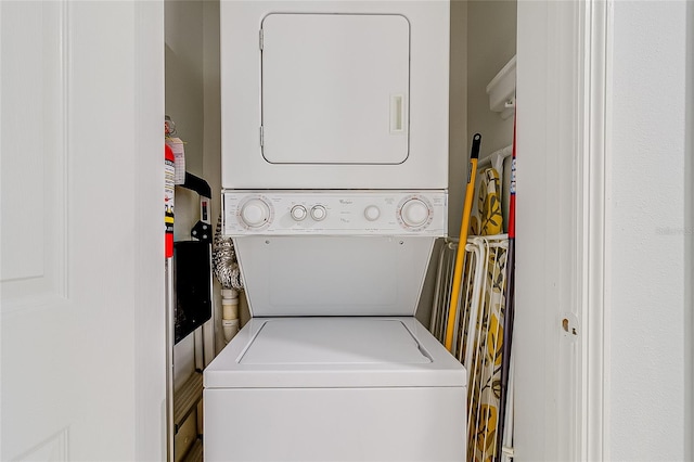 laundry area with stacked washer and dryer