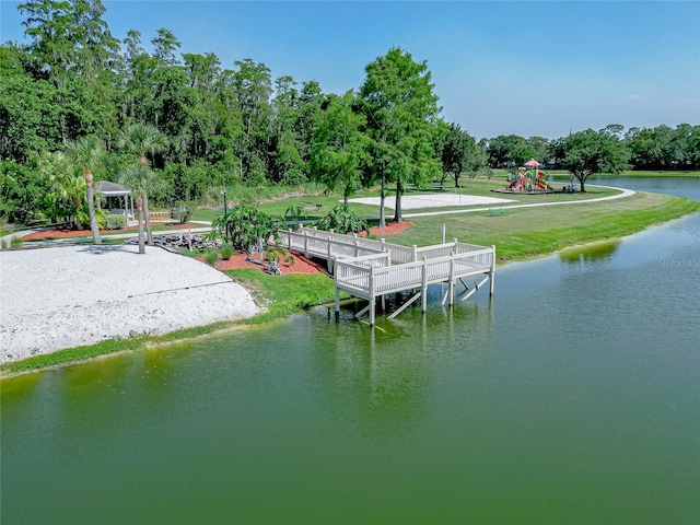 view of dock featuring a playground and a water view