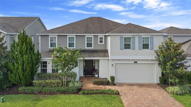 view of front facade with a garage and a front lawn