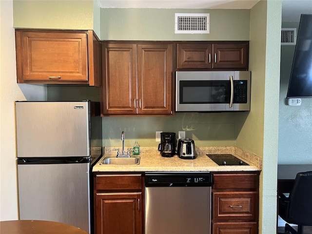 kitchen featuring stainless steel appliances and sink