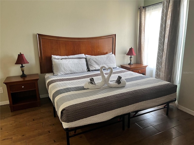 bedroom with dark wood-type flooring