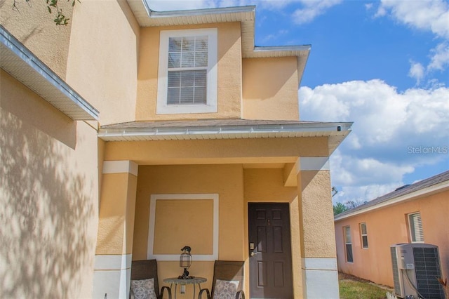 view of exterior entry with central AC unit