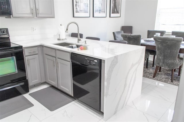 kitchen with black appliances, kitchen peninsula, sink, and light tile patterned flooring