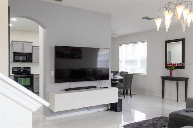 tiled living room with a chandelier