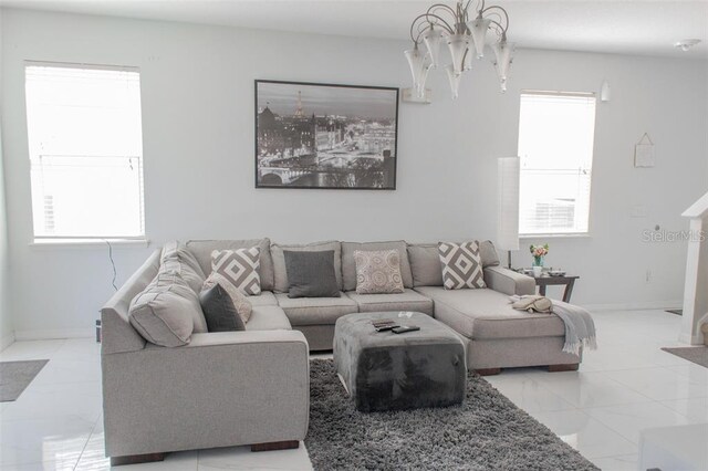 living room with a notable chandelier and light tile patterned flooring