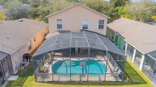 back of property with a yard, a lanai, a fenced in pool, and a patio