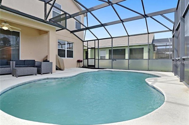 view of swimming pool featuring glass enclosure, an outdoor hangout area, and a patio area