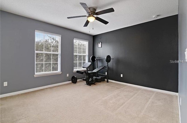 living area featuring light carpet, a textured ceiling, and ceiling fan