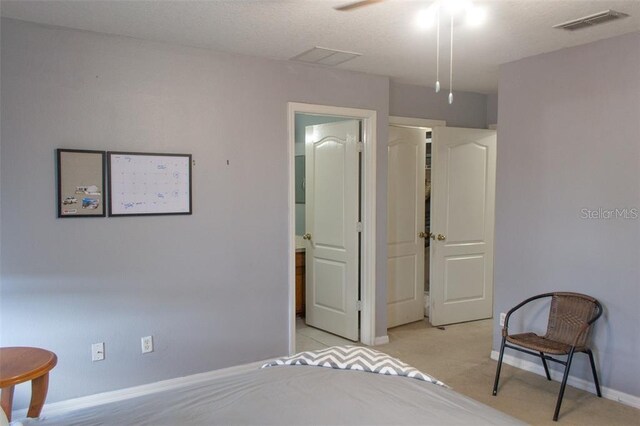 carpeted bedroom with ceiling fan and ensuite bathroom