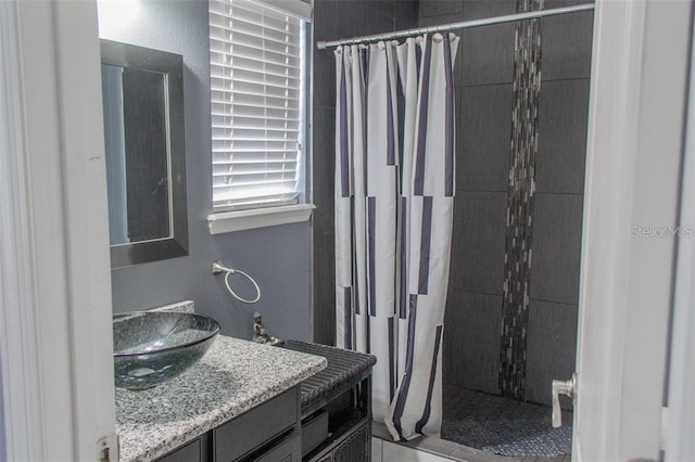 bathroom featuring a shower with shower curtain and vanity