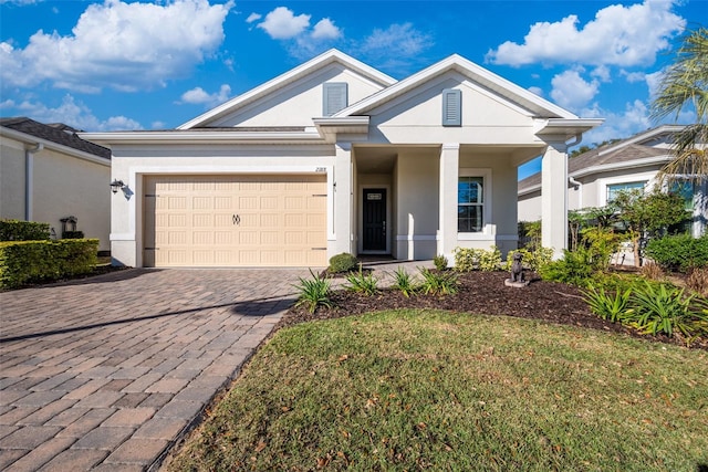 view of front of property with a garage and a front lawn