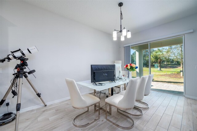 dining room with light hardwood / wood-style flooring and a chandelier