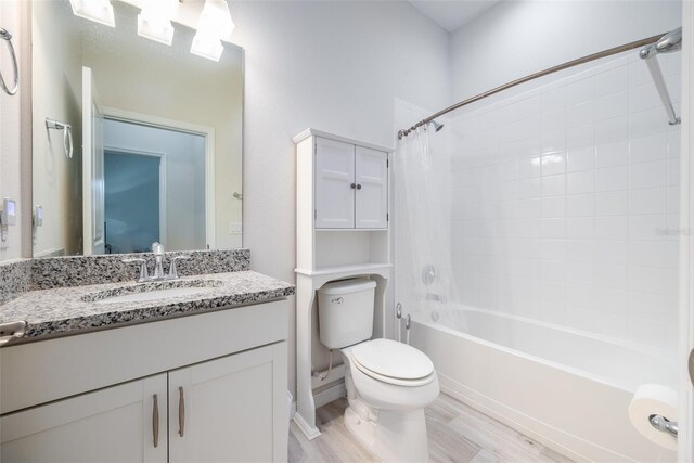 full bathroom with vanity, toilet, hardwood / wood-style flooring, and shower / bath combo