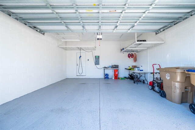 garage featuring a garage door opener and electric panel