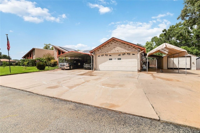 view of front of home featuring a carport and an outbuilding