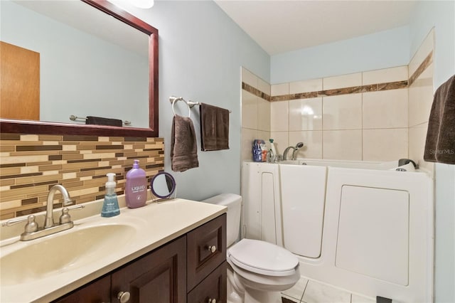 bathroom featuring backsplash, tile patterned floors, a bathtub, vanity, and toilet