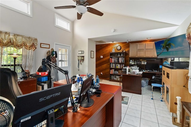 office space featuring light tile patterned floors, high vaulted ceiling, ceiling fan, and wooden walls