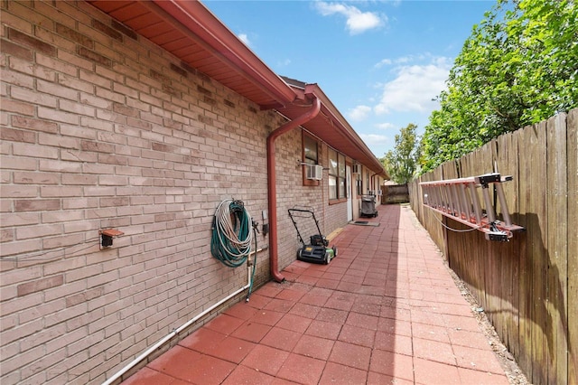 view of side of home with cooling unit and a patio area