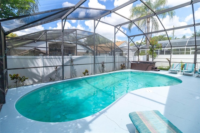 view of pool featuring glass enclosure and a patio