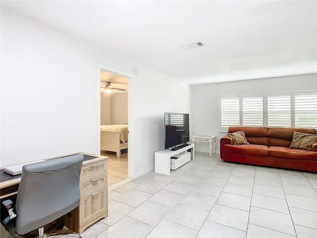 living room with a healthy amount of sunlight, ceiling fan, and light tile patterned flooring