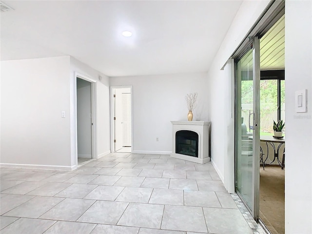 unfurnished living room with light tile patterned floors