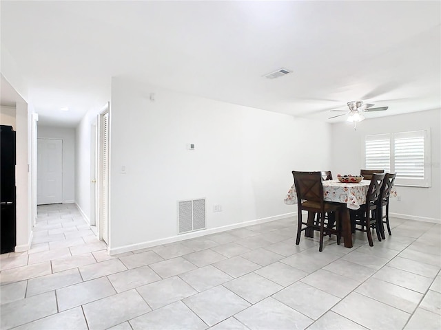 tiled dining area with ceiling fan