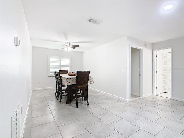 tiled dining area with ceiling fan