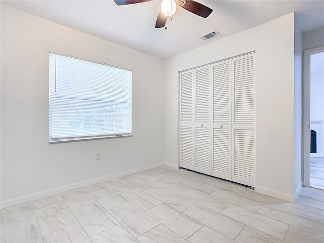 unfurnished bedroom featuring a closet and ceiling fan