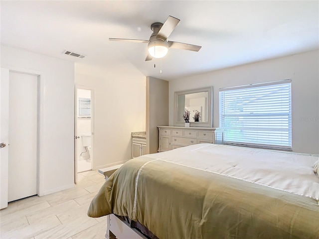 bedroom with ceiling fan and ensuite bath