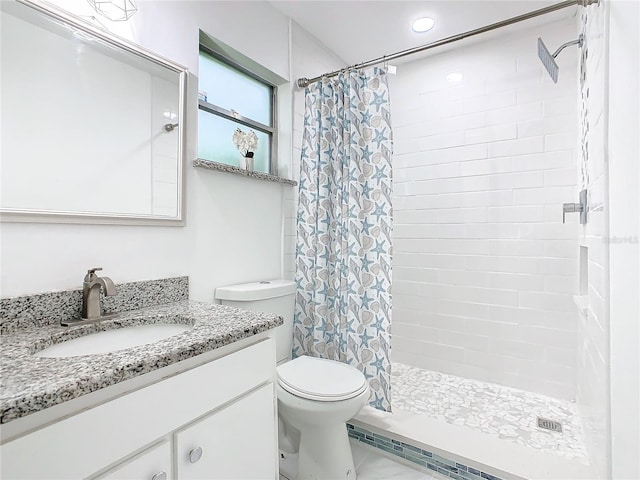 bathroom featuring vanity, toilet, and curtained shower