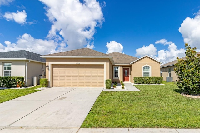 ranch-style house featuring a garage, central AC unit, and a front yard