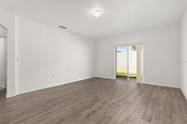 spare room with hardwood / wood-style floors