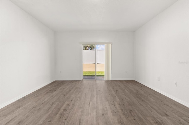 empty room with hardwood / wood-style flooring