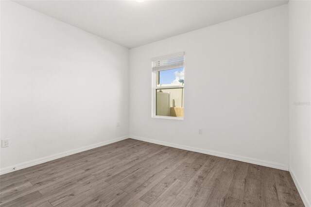 spare room with hardwood / wood-style flooring