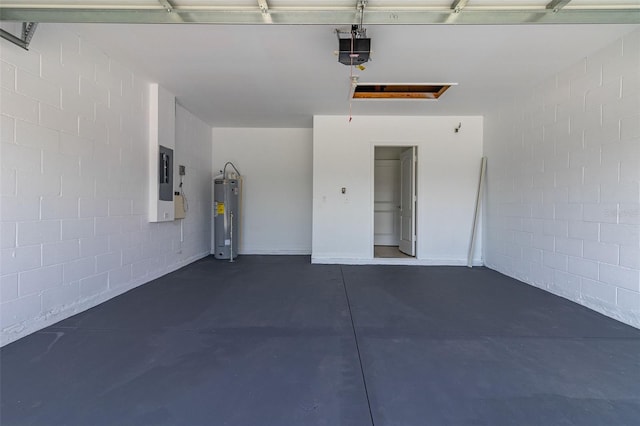 garage featuring water heater, a garage door opener, concrete block wall, and electric panel