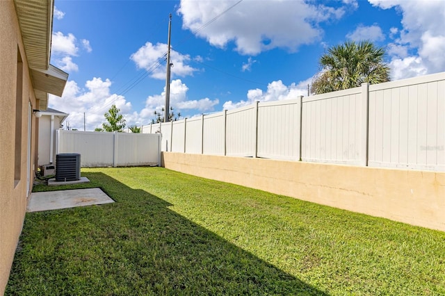 view of yard featuring central air condition unit and a fenced backyard