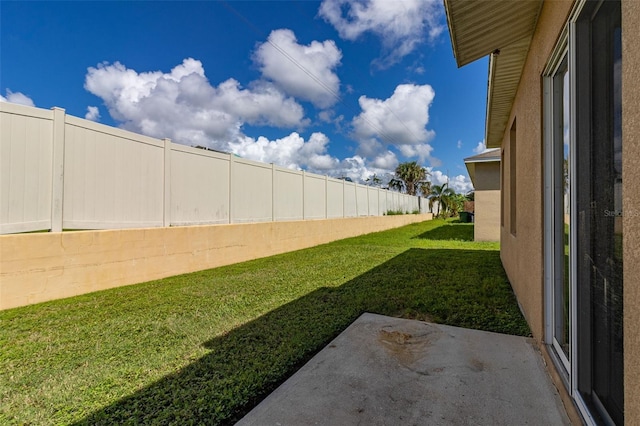 view of yard with a patio area and a fenced backyard